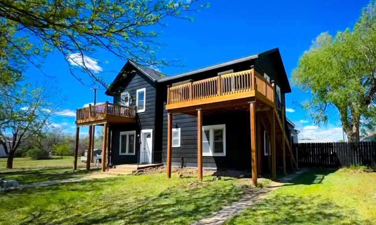 Russell Apartment | Rhinestone Cowgirl is a chic pink-inspired upper-level apartment just blocks from downtown Russell. Enjoy a cozy bedroom, living area with Smart TV, kitchenette, full bath, private balcony, and shared backyard with grill, firepit, and laundry.