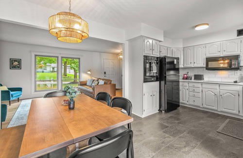 South Central Omaha House | Private hot tub + fire pit + screened in porch with character = your perfect starry nite escape