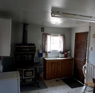 Bellvue House | Simple Country Cabin with Ornate Wood Stove in the Colorado Mountains of Poudre Canyon