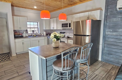 Dunnegan House | Unplug and unwind at this 2BR/2BA Hideaway, just a short walk to a swimming/fishing cove, backing to peaceful Corps land. Enjoy mornings in nature, afternoons by the water, and evenings around the firepit—perfect for couples, families, or friends!