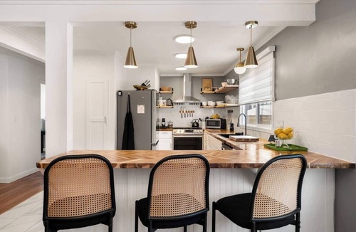 Kansas City House | Upscale comfort near Legends, KC Speedway & Sporting KC stadium. Chef's kitchen, private hot tub, & google fiber.