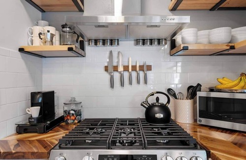 Kansas City House | Upscale comfort near Legends, KC Speedway & Sporting KC stadium. Chef's kitchen, private hot tub, & google fiber.