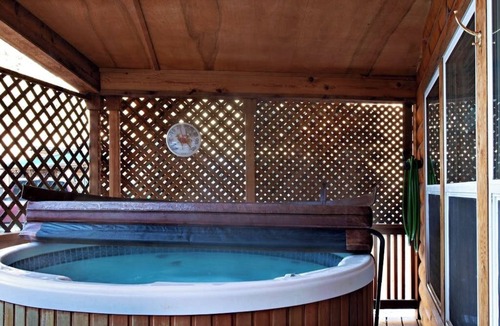 South Fork Cabin | Waterfront cabin with private hot tub, furnished deck, wood stove, & free WiFi
