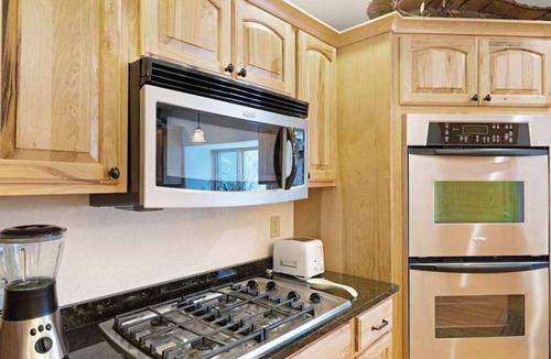 Eagle River Condo | Waterfront townhome with fireplace, private patio, & shared boat docks