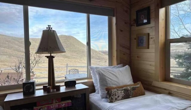 Quintessential Wyoming log cabin retreat near Bighorn National Forest, Lake DeSmet, Buffalo, Big Horn, and Sheridan. This charming main house comfortably sleeps 6 with a king bed, twin beds, and queen sleeper sofa. Pets welcome.