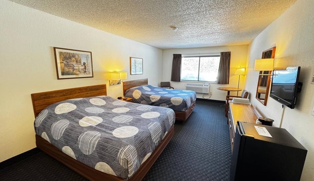 Two queen beds, private bathroom, mini fridge, and single-serve coffee maker.