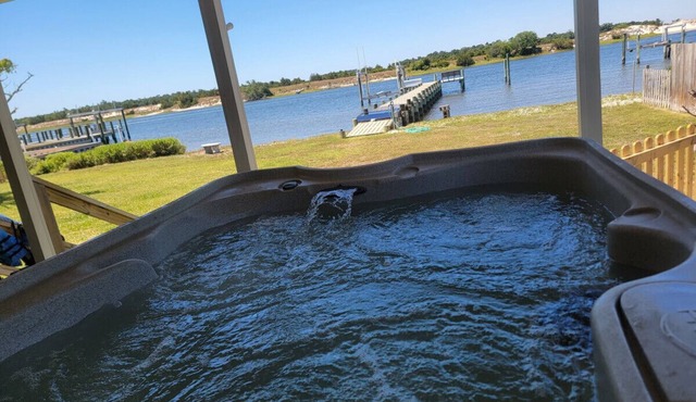 Waterfront with private dock, Hot tub, & swim mat. Large fenced backyard and screened in porch for relaxing.